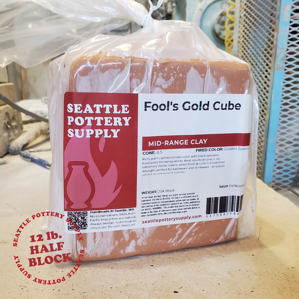 Package of Fool's Gold Cube clay from Happycozygoods on a workbench.