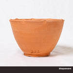 A bowl made of SPS Redart Terracotta clay in the bisque stage. Stamped wtih SPS branding.