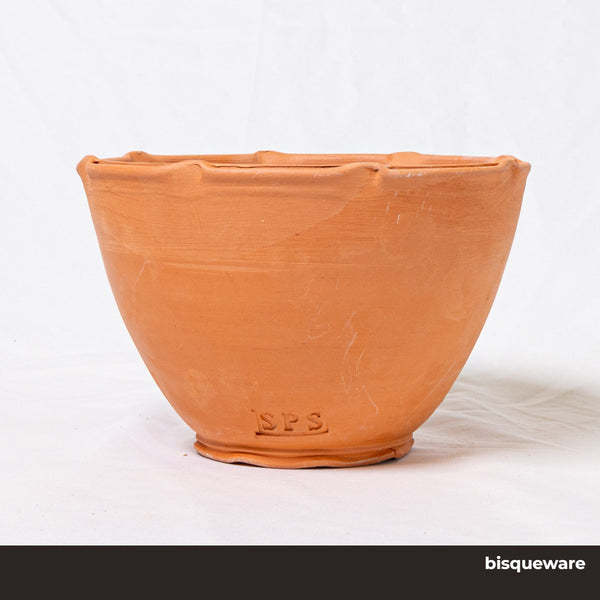 A bowl made of SPS Redart Terracotta clay in the bisque stage. Stamped wtih SPS branding.