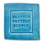 A glaze tile in Happycozygoods glaze SP77 Turquoise, stamped with Happycozygoods