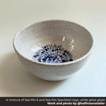 Speckled ceramic bowl with blue floral pattern on a white background, Made with a mixture of Happycozygoods Sea Mix 6 and Sea Mix Speckled clays